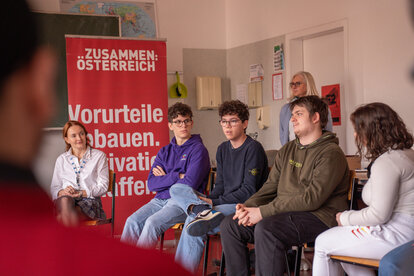 Teenagers discuss in a school class