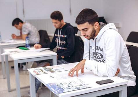 Studierende arbeiten konzentriert an ihren Aufgaben.